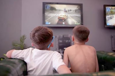 playing video games with gaming console connected to tv